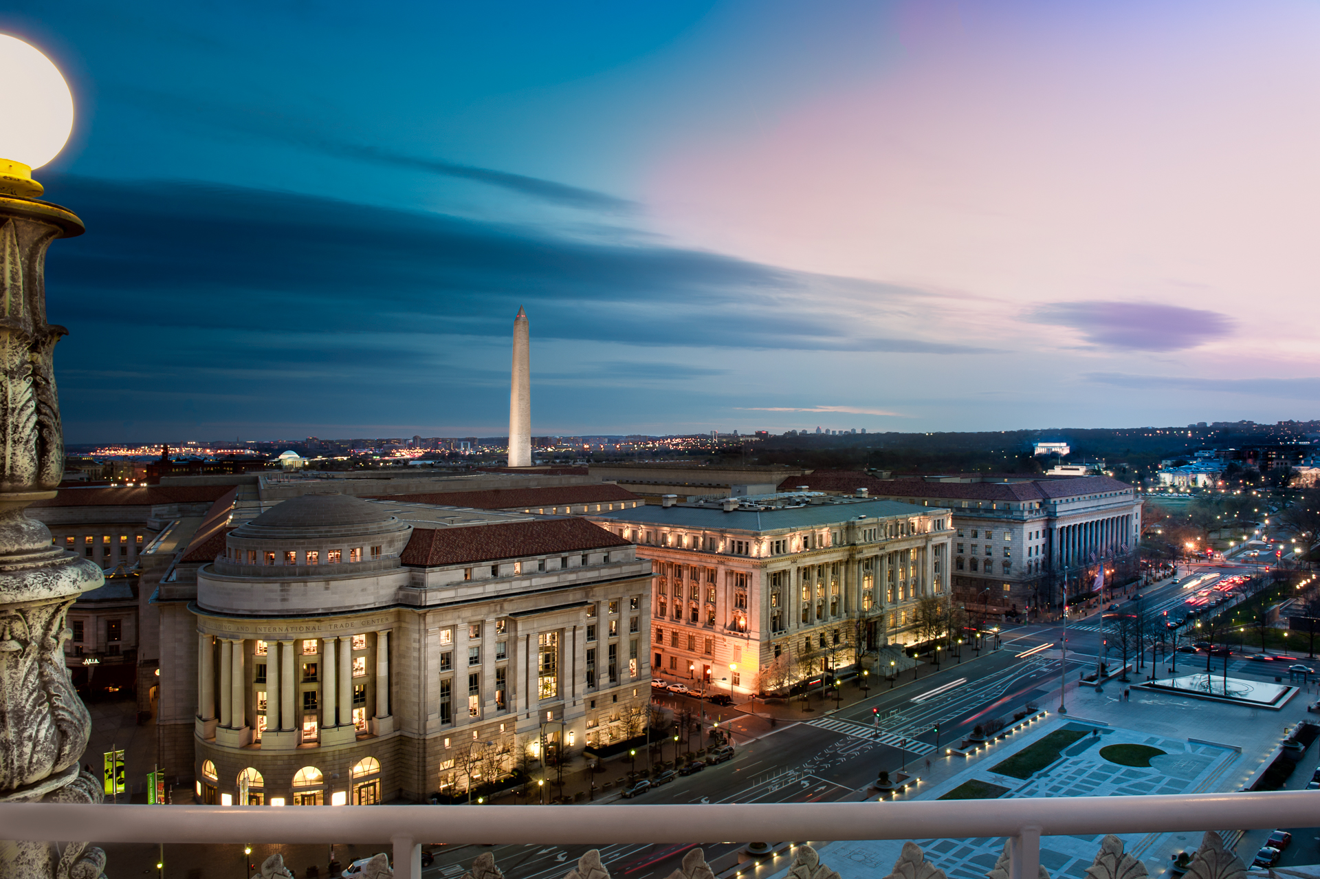 Sunset view from The Warner Theater Building over Freedom Square, Pennsylvania Avenue, The Reagan Building and The Washington Monument
